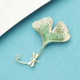 radiant ginko dragonfly brooch blue background
