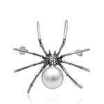 silver metal spider brooch