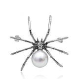 silver metal spider brooch